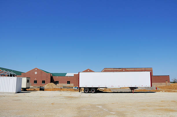istock Commercial Real Estate Building Construction Site with Tractor Trailer 182515361