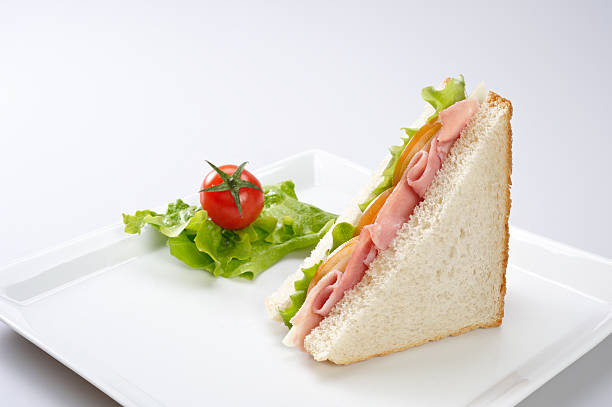 Ham and cheese sandwich Ham and cheese sandwich with tomato and lettuce. ham and cheese sandwich stock pictures, royalty-free photos & images