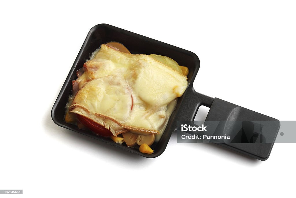 Raclette Pan with Food Raclette Pan with Food. Isolated on white. Raclette is a  cheese and also a dish. This pan is used in a modern electric table-top grill. Raclette Stock Photo