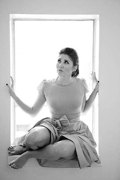 istock Beautiful young woman trapped in a window 182515735