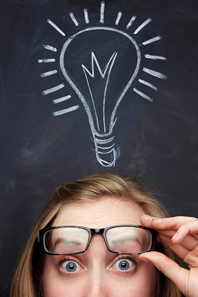 istock Woman with a chalk drawn idea metaphor 182515760