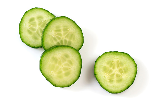 Fresh cucumber slices on white background