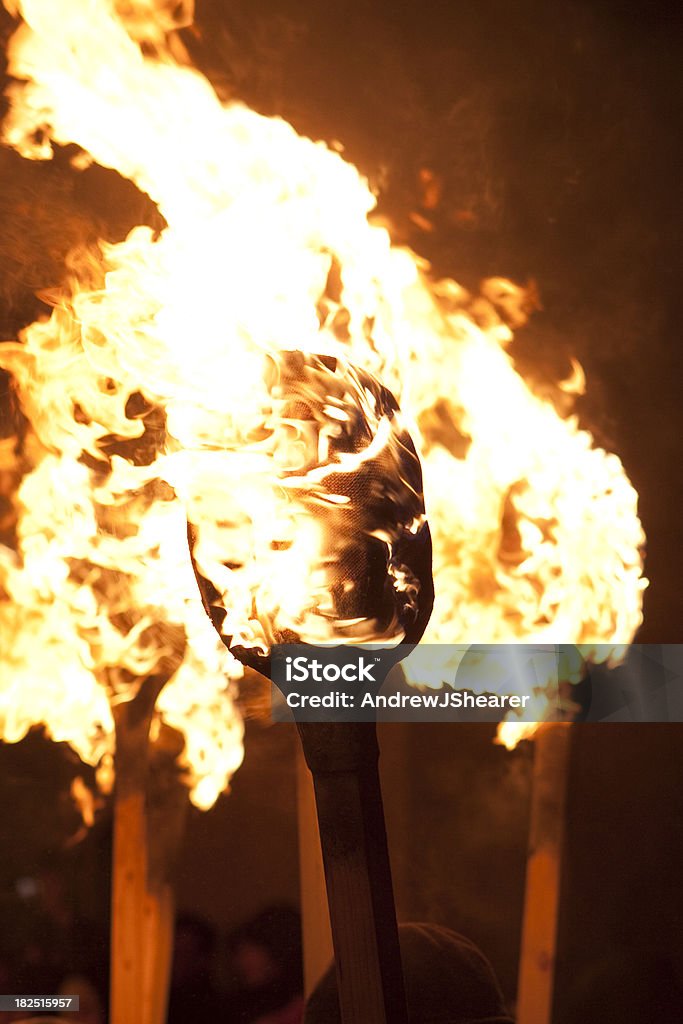 Up Helly Aa Torches "A row of torches on fire shot during Up Helly Aa.The stunning 'Up Helly Aa' takes place in Lerwick, Shetland Isles, Scotland on the last Tuesday in January every year. The day involves a series of marches and visitations by the Guizer Jarl (after a 15 year wait) and his squad of fellow vikings, culminating in a torch lit procession of over 800+ vikings and guizers and the burning of the galley. Watched over by thousands of locals and visitors who travel from all over the world to see the spectacular event." Burning Stock Photo