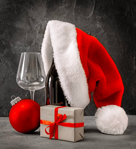 istock Christmas Bottle wine glass santa hat 1825162864