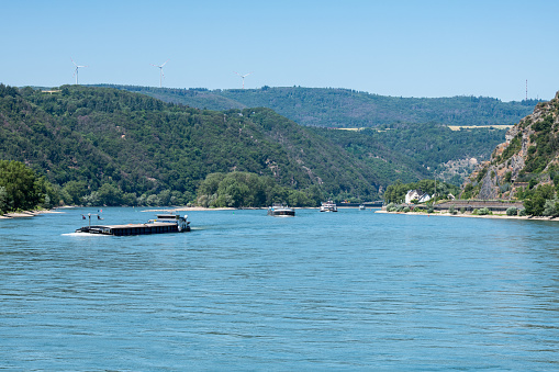 Cargo vessels navigating upstream on the river Rhine near Koblenz in Germany.
