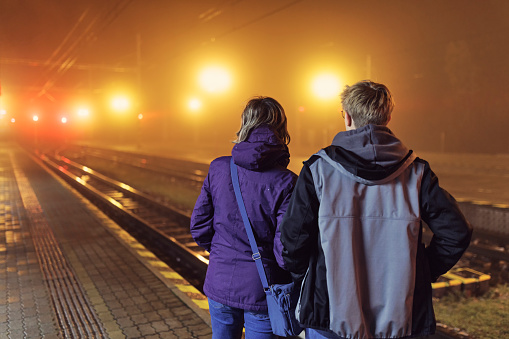 Mother and teenage son waiting in the Štrbské Pleso train station on a foggy night
Shot with Canon R5
