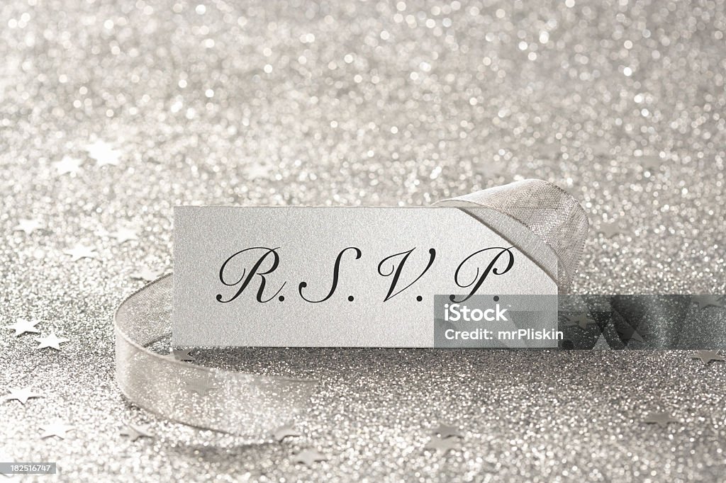 R.S.V.P. place card R.S.V.P. place card shot against a silver glittery background. Shallow depth of field, focus on the card and text, blank version available. RSVP Stock Photo
