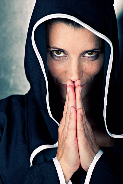 istock beautiful praying nun, portrait indoor 182517871