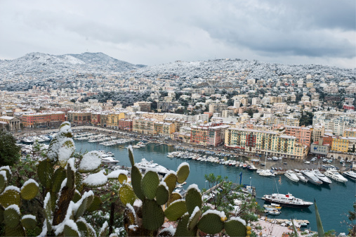 A view of Nice Port and the snow covered hills and villas of Mont Boron after a heavy snow fall