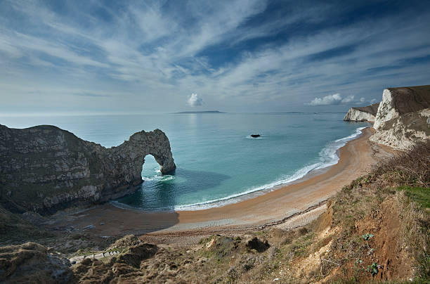 Durdle Door and Bats Head view "An image from the coast path at Durdle Door on a glorious spring day on the Jurassic coastline of Dorset, South West U.K" jurassic coast world heritage site stock pictures, royalty-free photos & images