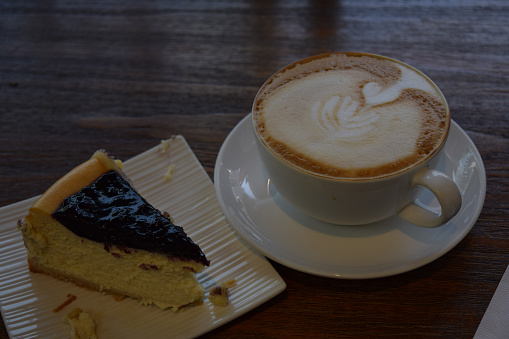 Coffee with froth art and cheesecake.