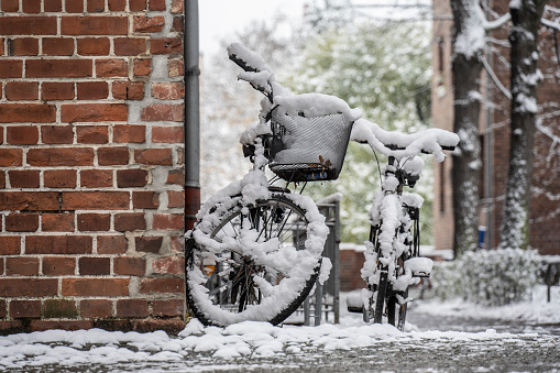 Leipzig, Germany. 1 of December 2023.\nParked bikes covered in snow.