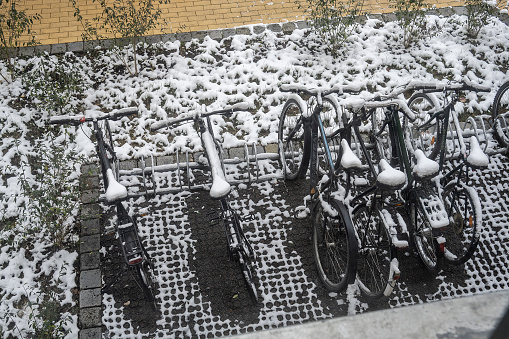 Leipzig, Germany. 29 of November 2023.\nParked bicycles covered with snow.