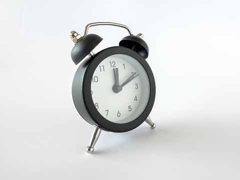 Cut out image of a small retro alarm clock on white background