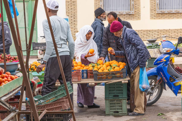 Bir Al Huffay, Sidi Bouzid, Tunisia. March 19, 2023. Shopping for oranges at the outdoor souk in Bir al Haffay.