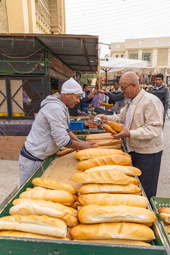 Bir Al Huffay, Sidi Bouzid, Tunisia. March 19, 2023. Shopping for fresh bread at the outdoor souk in Bir al Haffay.