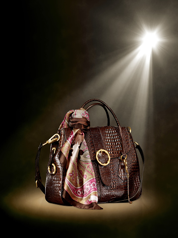Spot lit leather handbag on stage background