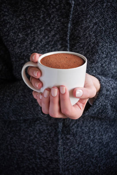istock holding a cup of hot chocolate 1825264260