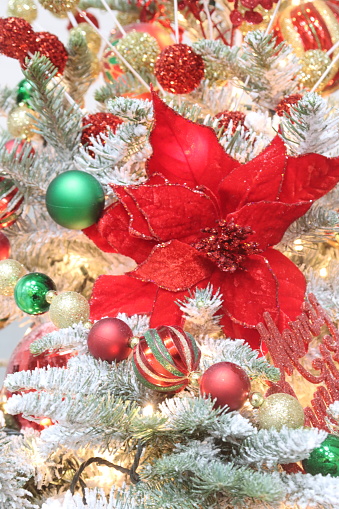 A bright poinsettia as a Christmas tree ornament