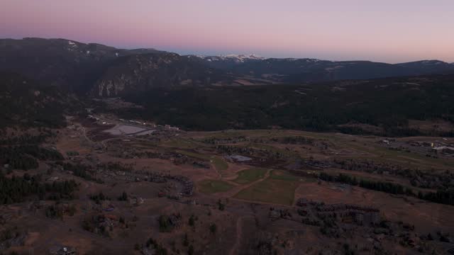 Drone aerial flyover at sunset of big sky golf course