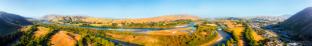 Waitaki river by Kurow town in New Zealand on South island - wide scenic aerial panorama of valley.