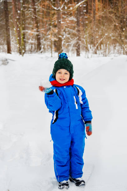 istock Cheerful child sculpts snowballs outdoors on a winter day. 1825345170