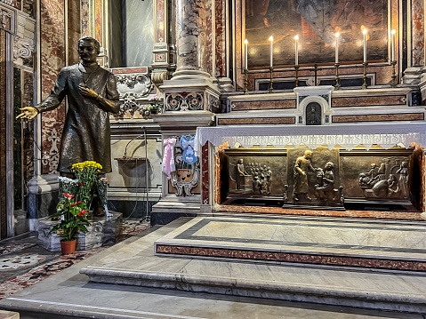 Naples, Italy - September 27, 2023: Statue of Saint. Giuseppe Moscati in the Church of Jesus in Naples, Italy and his tomb nearby.