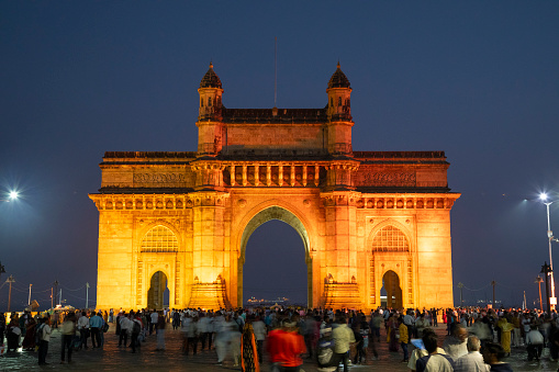 This image captures the iconic Gateway of India in Mumbai, illuminated against the night sky. The grand archway, a symbol of colonial history and Indian independence, takes on a different character after dark, with strategic lighting accentuating its intricate Indo-Saracenic architecture. The large arches and detailed reliefs are highlighted, creating a dramatic and majestic presence on the waterfront. The photograph aims to showcase the Gateway of India not just as a historical monument but as a captivating sight in Mumbai's nightscape, drawing both locals and tourists to experience its grandeur in the tranquillity of the night.