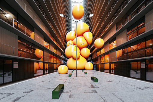 A bunch of big yellow spheres stuck between two buildings