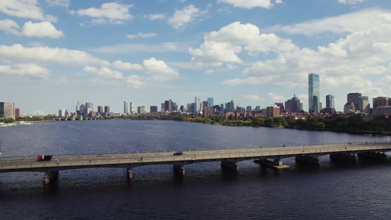 Boston City Skyline, People And Cars Travelling On Harvard Bridge