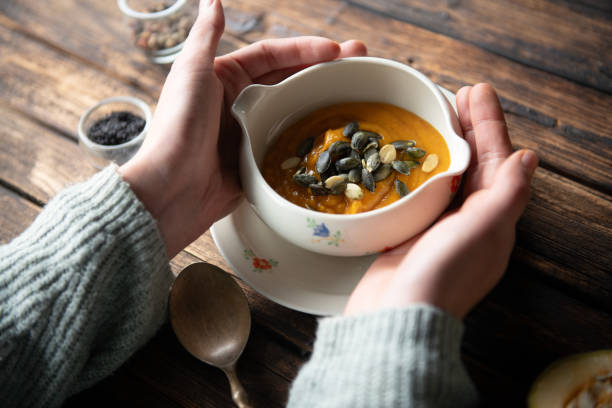 Serving roasted-pumpkin soup in a white bowl