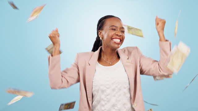 Money rain, financial freedom and dancing black woman with wealth, cash and excited isolated on blue background. Bonus, salary or income with lotto happy winner, dollar bills and cashback in studio