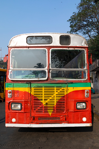 This image features a colorful, old bus in Mumbai, showcasing a vivid aspect of the city's public transport history. These buses, painted in bright hues and often adorned with unique designs, are a testament to the lively and dynamic character of Mumbai. The photograph captures the charm of these vintage vehicles, each telling its own story through worn paint and time-etched features. They serve as a nostalgic reminder of the city's past, contrasting with the modernity of Mumbai's current transportation system. The image aims to convey the cultural and historical significance of these old buses, highlighting their role in the everyday life of Mumbaikars and the city's evolving urban narrative.