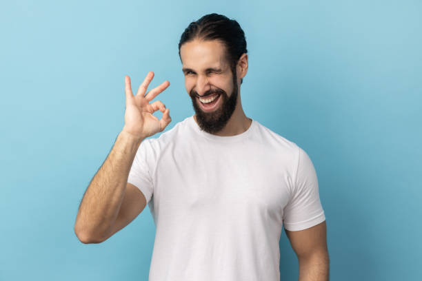istock Man standing, looking at camera showing Ok sign gesture, expressing positive emotions. 1825497114