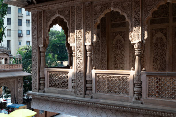 This image features the Radhagopinath Temple in Mumbai, a spiritual haven known for its serene ambience and beautiful architecture. The temple, dedicated to Lord Krishna and Radha, is a fine example of traditional Indian architecture with ornate carvings and intricate designs. The photograph captures the temple's detailed artwork and its structure's warm, welcoming hues. Nestled within the bustling city, the Radhagopinath Temple is a peaceful sanctuary, offering a place of worship and contemplation for devotees and visitors alike. The image aims to convey the temple's spiritual significance and its role as a centre for cultural and religious activities in Mumbai, highlighting its beauty and tranquillity amidst the urban landscape.