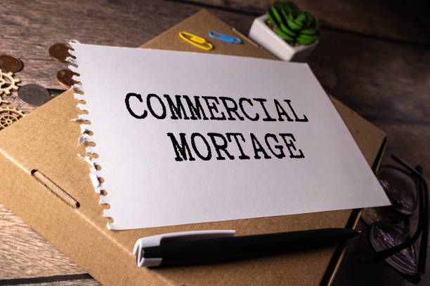 istock COMMERCIAL MORTGAGE, text on white notepad paper. on a white photo with torn paper 1825524162