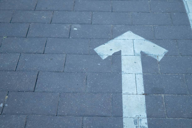Directional arrow straight ahead on the road