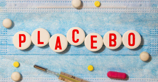istock On a blue background, multi-colored pills and a wooden block with the text PLACEBO. View from above. Medical concept 1825524357