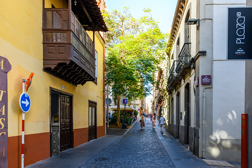A long narrow cobblestone street through the historic old town district of Santa Cruz de Tenerife, Spain, on the Canary Island of Tenerife.