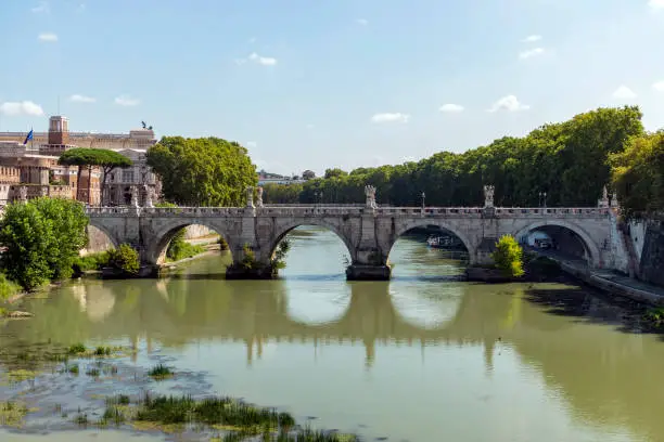 Ancient Roman bridge with reflections in Rome, Italy