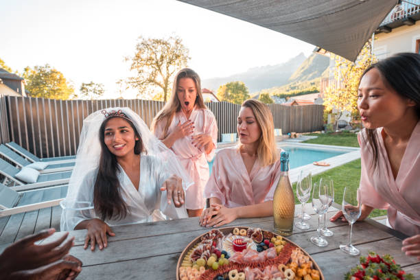 istock Poolside Revelry with Indian Bride and Diverse Friends Displaying Engagement Ring 1825631549