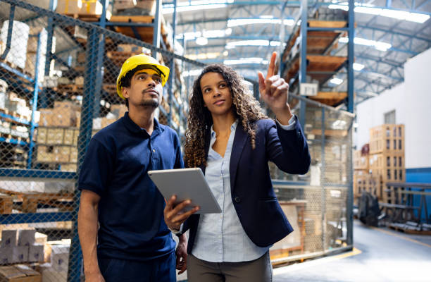 istock Manager talking to an employee at an industrial warehouse 1825644893