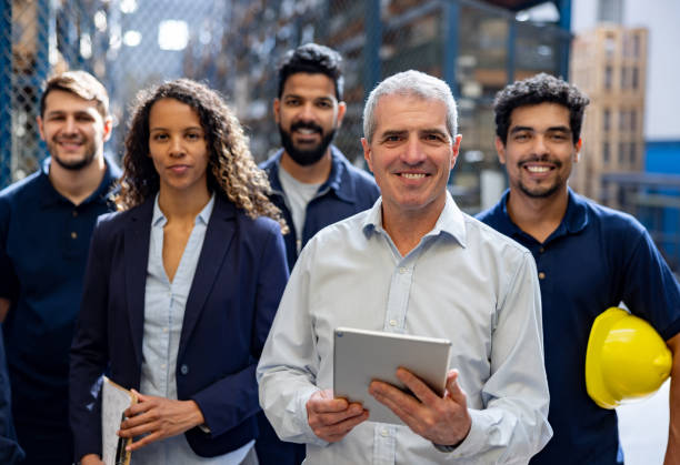istock Happy group of employees at a distribution warehouse 1825645422