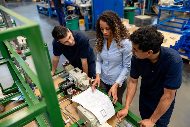 istock Engineer showing workers how to assembly a waterpump at a factory 1825645435