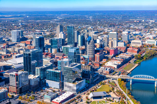 Above Downtown Nashville Buildings of downtown Nashville, Tennessee shot from above via helicopter at an altitude of about 1200 feet. nashville tennessee bridge stock pictures, royalty-free photos & images