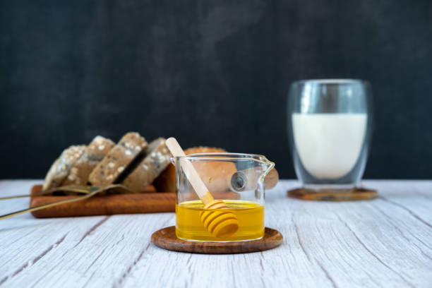 istock Honey and sticks for pouring With bread and milk for breakfast 1825709681