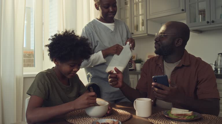 Black Female Doctor Giving Husband and Son Breakfast before Work