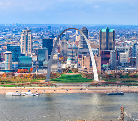 St. Louis, Missouri, USA downtown cityscape with the arch and courthouse at dusk.