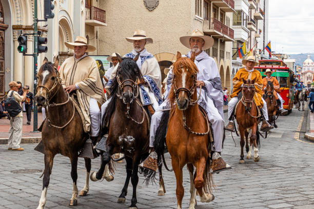 Cuenca, Ecuador - October 28, 2023: Independence Day celebration. A large group of ranchers and farm workers at a horse parade in the historic center of Cuenca