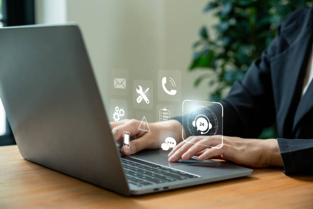 istock Businesswomen using laptop with support customer icon. 1825810883